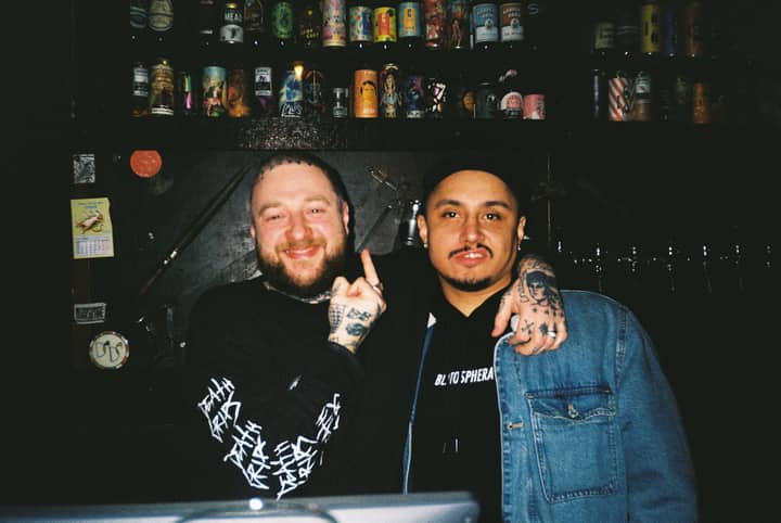Two friends posing together at a bar in Moscow, displaying camaraderie and nightlife vibes.