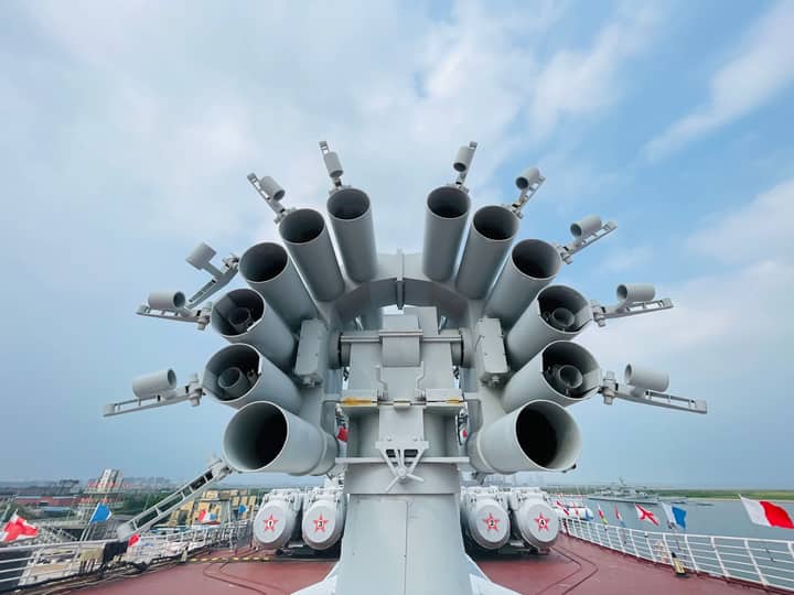 Close-up of naval artillery on a warship at Tianjin Harbour, China, showcasing military might.
