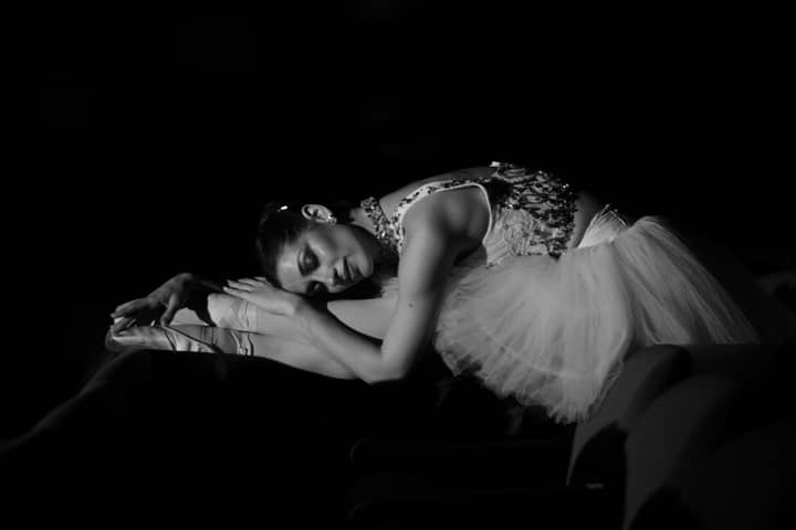 Elegant ballerina gracefully posing in monochrome, showcasing poise and motion.
