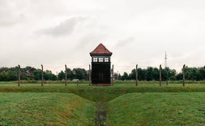 A solemn view of a guard tower at Auschwitz concentration camp, reflecting on history.
