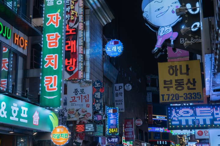 Bright neon lights and bustling night scene in downtown Seoul, Korea.