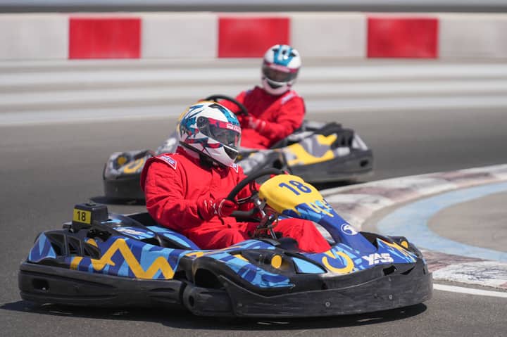 Two racers competing in a thrilling go-kart race at Yas Marina Circuit in Abu Dhabi.