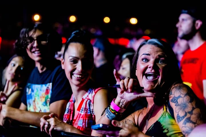 A vibrant crowd at a music concert enjoying the lively atmosphere and entertainment.