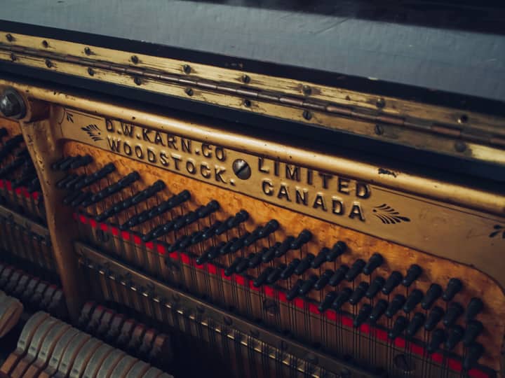 Close-up of vintage D.W. Karn piano interior, showcasing intricate mechanics and design. Shot in France.