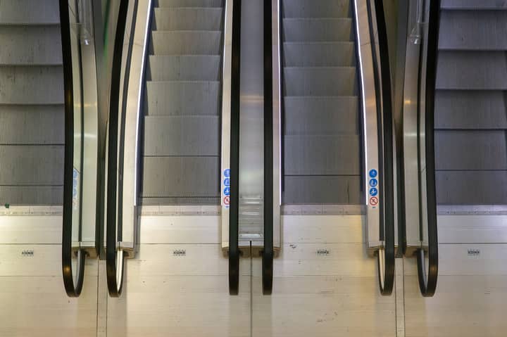 Aerial perspective of escalators in a Rotterdam building, showcasing industrial design and symmetry.
