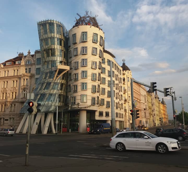 Explore the unique Deconstructivist architecture of the Dancing House in Prague at sunset.