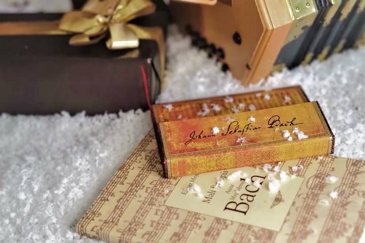 Beautifully wrapped gift with Bach-themed music box, perfect for holiday decor on a white background.