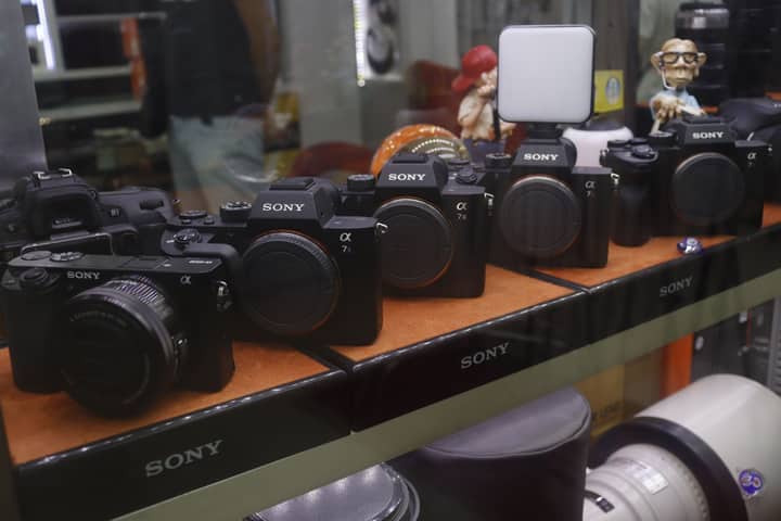 Showcase of Sony cameras in a retail store display.