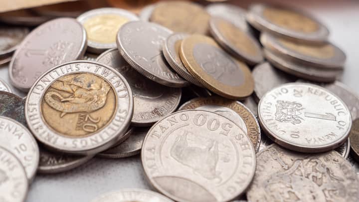 A detailed close-up image showcasing various Kenyan shilling coins, emphasizing their textures and inscriptions.