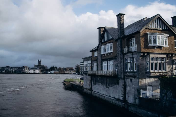 Traditional architectural houses lining the Shannon River in Limerick, Ireland.