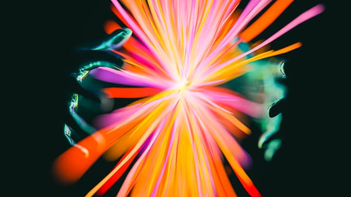 Abstract display of colorful lights and hands creating a vibrant, magical effect.