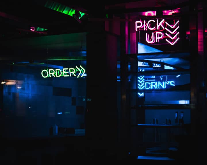 Vibrant neon signs illuminate a Berlin street, showcasing nightlife energy.