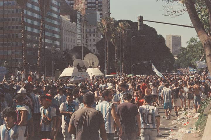 Lively street scene with football fans celebrating in Buenos Aires, Argentina.