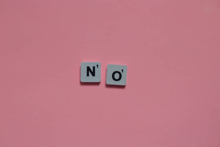 Letters N and O from a word game on a pink background. Minimalist and playful.