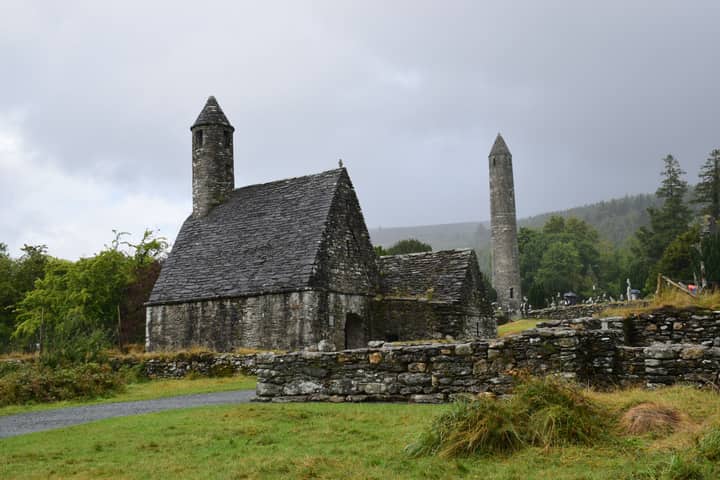 A serene view of the ancient St. Kevin's Church against an overcast sky in Glendalough, Ireland.