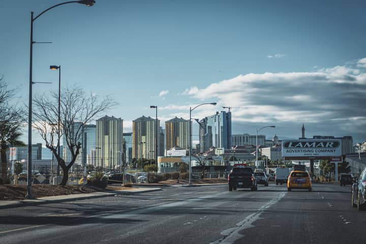 Dynamic view of Las Vegas skyline with bustling street traffic and modern skyscrapers.