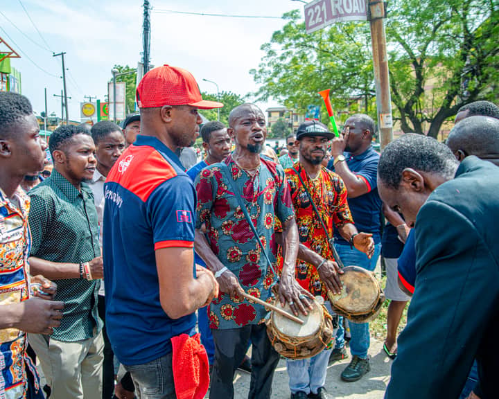 Energetic street musicians performing traditional drumming in Lagos, Nigeria.
