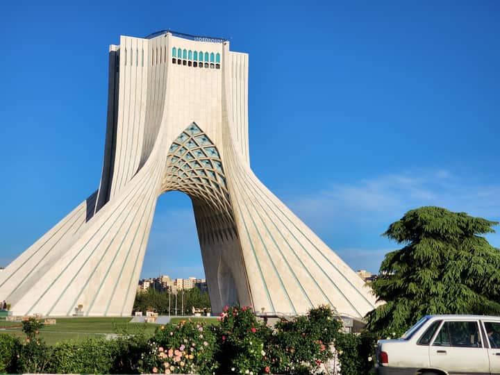 Iconic Azadi Tower in Tehran, Iran captured on a sunny day showcasing its unique architecture.