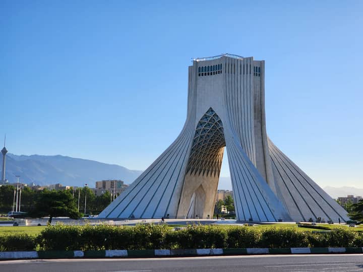 Iconic Azadi Tower in Tehran, Iran, under clear blue skies, perfect for travel inspiration.