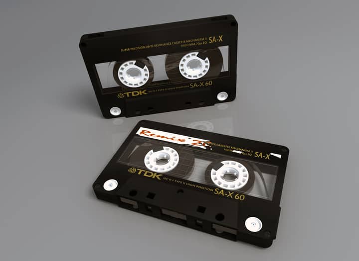 Two vintage TDK SA-X 60 cassette tapes showcasing retro audio technology on a reflective surface.