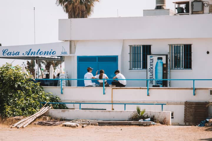 People enjoy a casual moment outside Casa Antonio in Málaga, Spain.