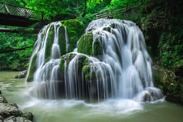 Discover the breathtaking beauty of Bigăr Waterfall, a serene cascade in Romania's lush green forest.