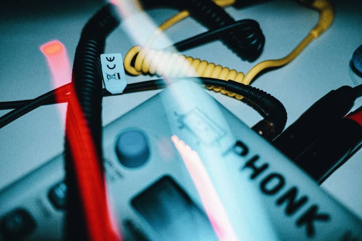 Artistic close-up with wires and vintage device, showcasing intricate detail with colorful lighting.