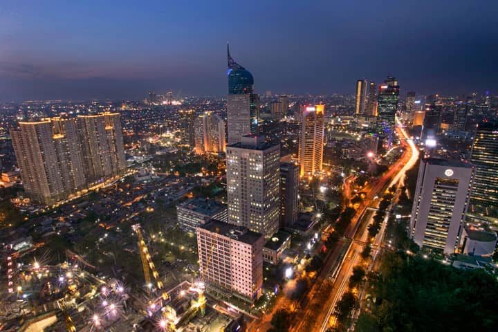 A stunning aerial view of Jakarta's skyline highlighting modern skyscrapers and vibrant city lights.