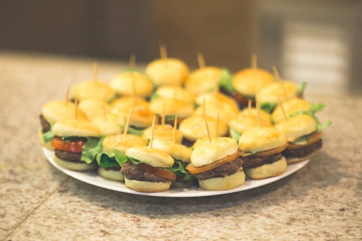 A mouthwatering plate of mini burgers perfect for appetizers or snacks at any gathering.