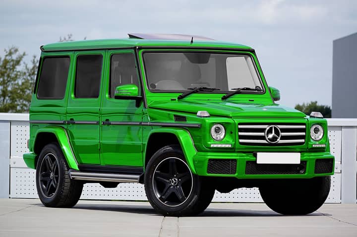 Bright green Mercedes-Benz G-Class SUV parked outdoors showcasing luxury and modern design.