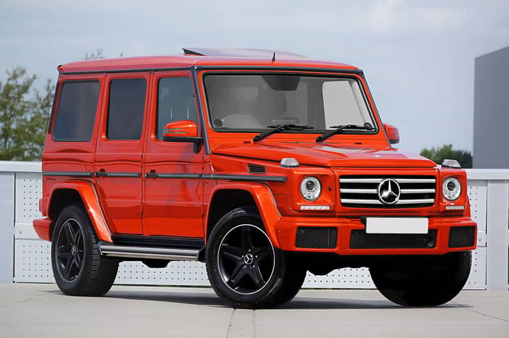 Striking red Mercedes-Benz SUV captured in a modern outdoor setting.
