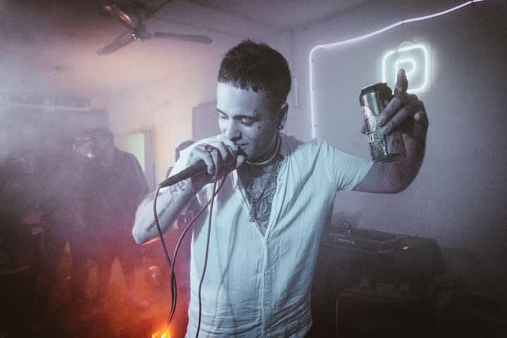 A dynamic scene of a singer passionately performing with a microphone in a vibrant club atmosphere.
