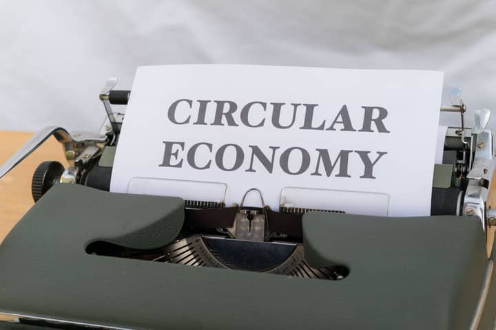Vintage typewriter typing 'Circular Economy' document emphasizing sustainability.