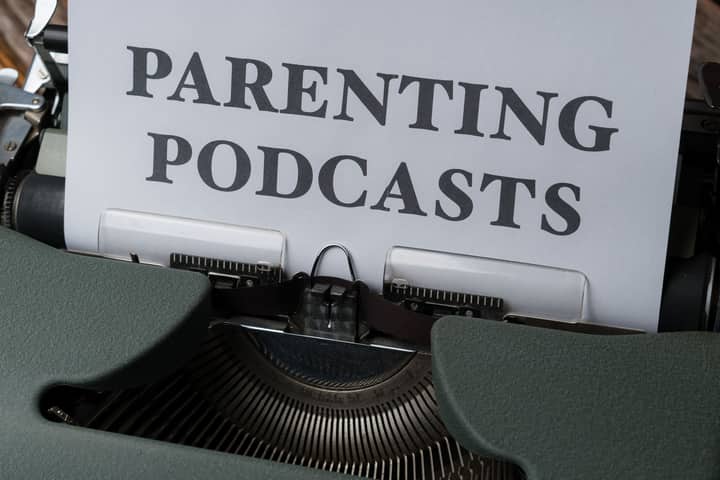 Close-up of a vintage typewriter with a sheet titled 'Parenting Podcasts'.