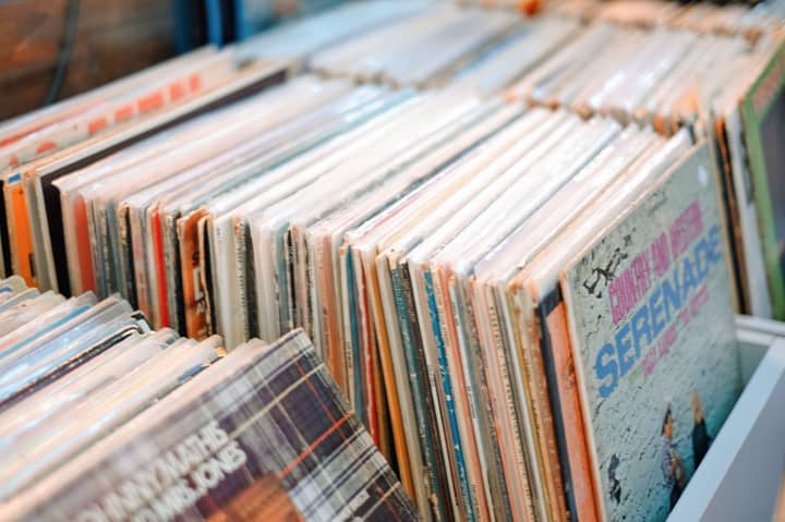 Close-up of vintage vinyl records in a store, showcasing retro album art.