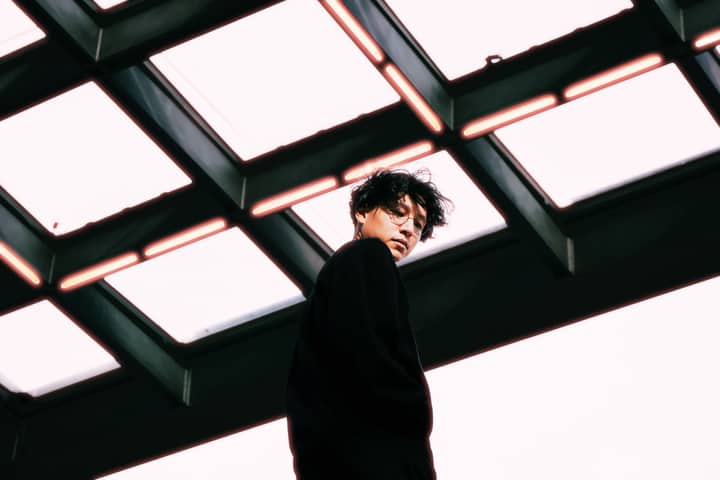 Stylish portrait of a person under a glass ceiling in Berlin, featuring modern architecture.