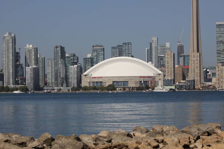 Skyline of Toronto with CN Tower and Rogers Centre by the waterfront.