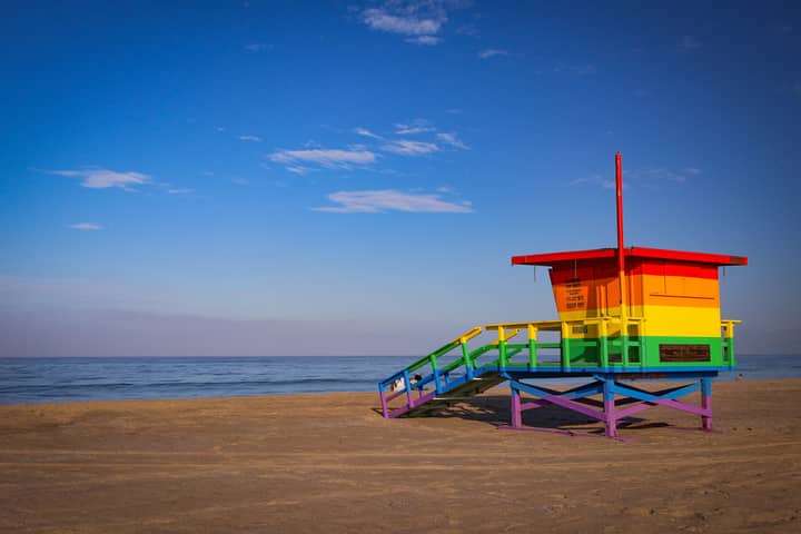 Colorful rainbow lifeguard tower on the sandy shores of Santa Monica Beach, Los Angeles, CA.