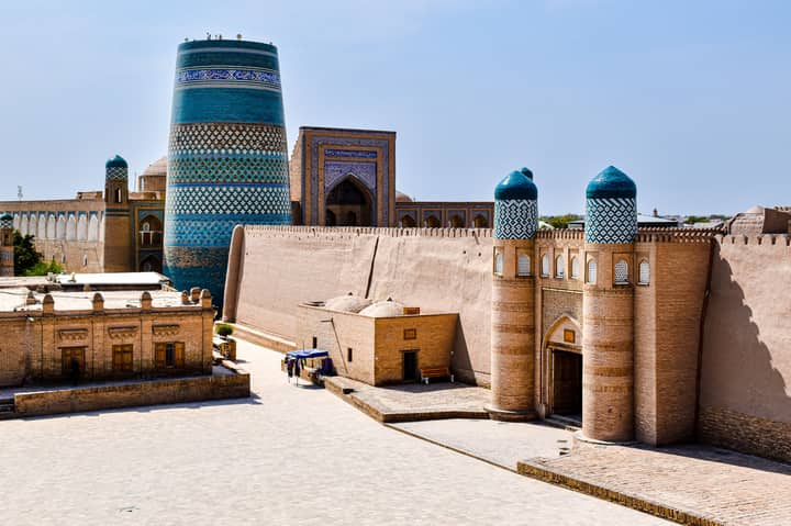 View of the iconic Kalta Minor Minaret in Khiva, showcasing Islamic architecture in summer.