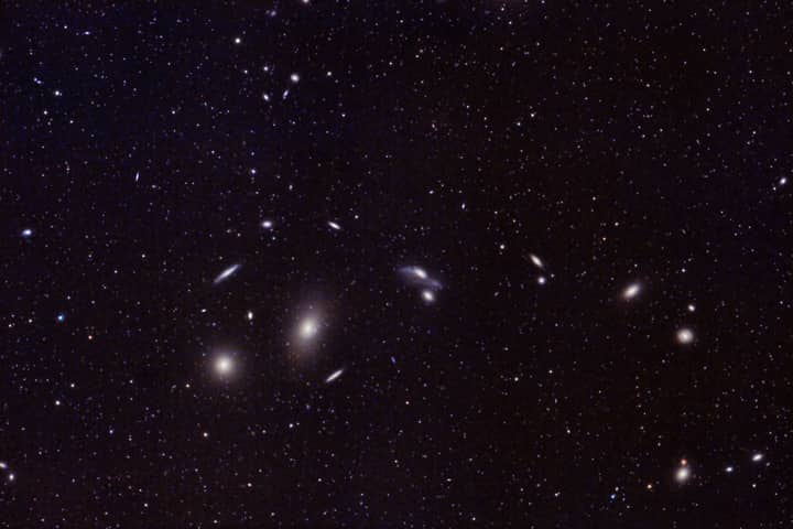 Captivating image of distant galaxies and star clusters in the vast universe. Perfect for astronomy enthusiasts.