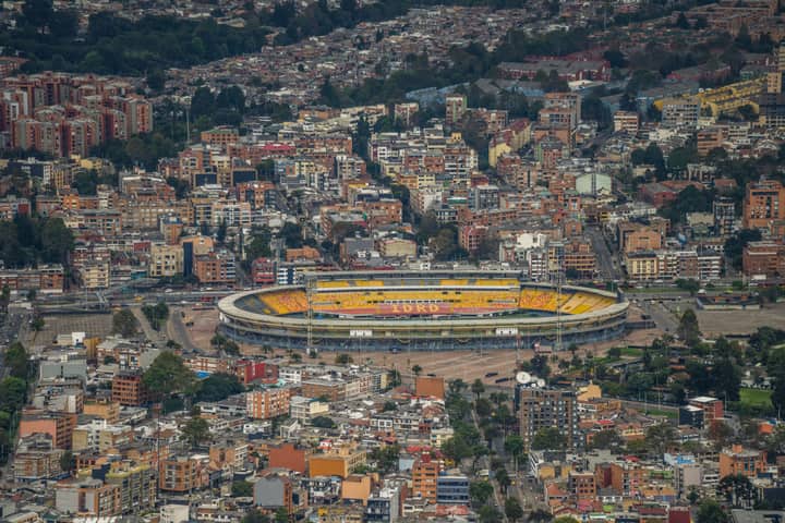 Aerial view of Bogotá's urban landscape featuring Estadio El Campín.