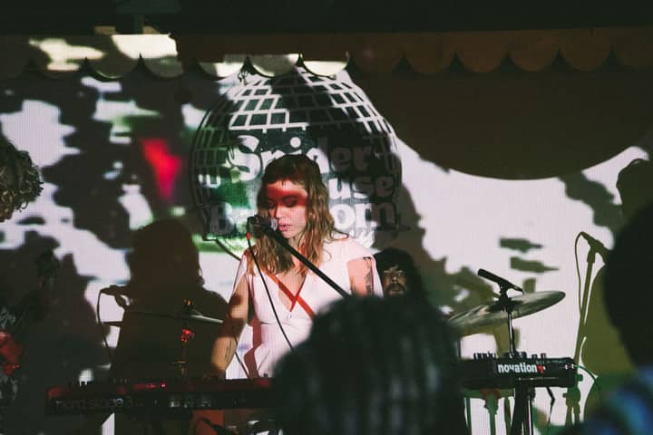 A captivating live music performance featuring a female musician with dramatic shadow effects on stage.