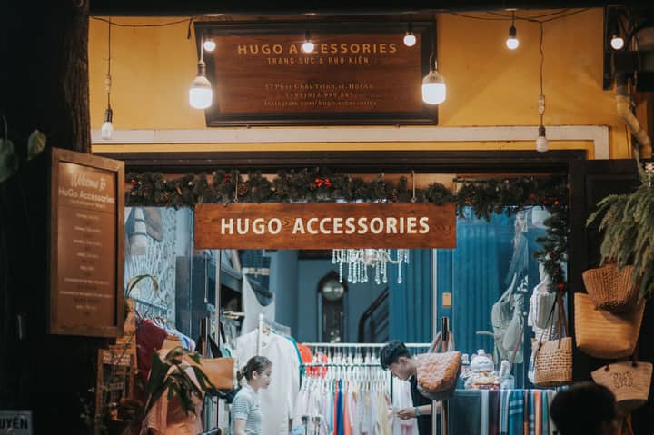 Cozy nighttime view of Hugo Accessories boutique entrance in Hoi An, Vietnam.
