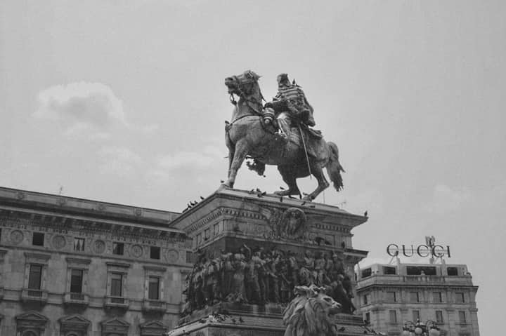 Black and white photo of Vittorio Emanuele II equestrian statue in Milan, Italy.
