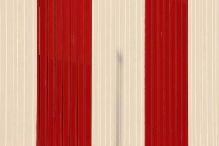 Close-up of a red and white striped wall in Jönköping, Sweden. Modern architectural design.