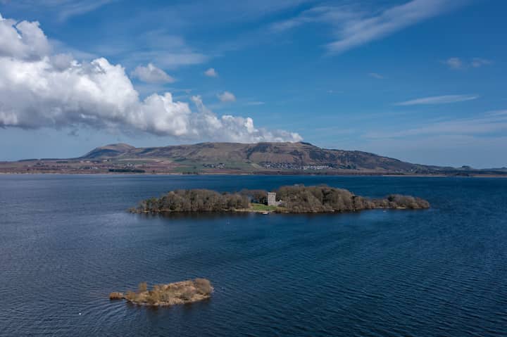 Scenic aerial capture of Loch Leven and the historic castle island in Scotland.