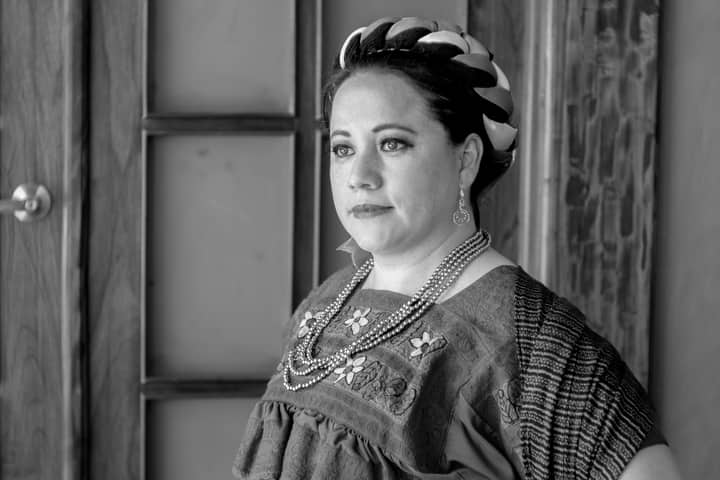 A striking black and white portrait of a woman in traditional Mexican attire, captured in Huauchinango, Mexico.