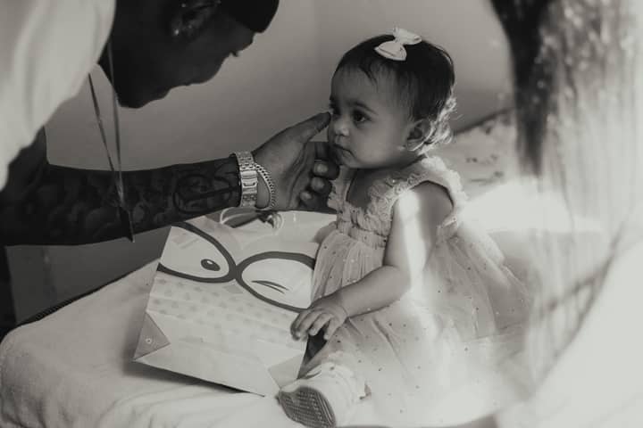 A touching black and white photograph of a father gently touching his daughter's face.