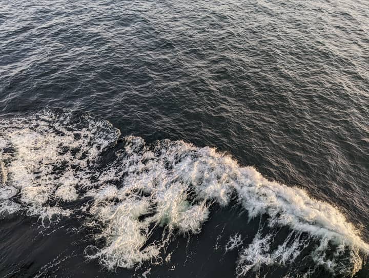 Top-down view of ocean waves and ripples creating foam. Ideal for nature themes.