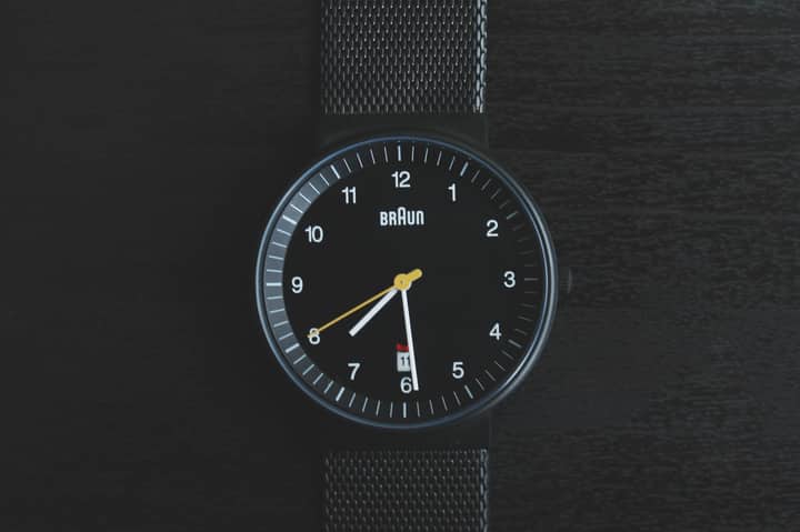 Elegant black wristwatch with a sleek design and precise timekeeping features.